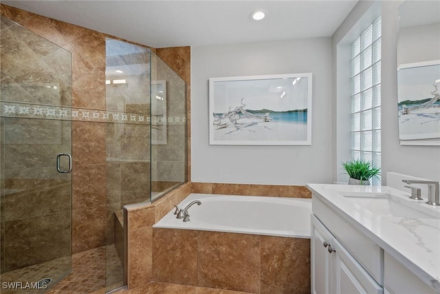 bathroom with a stall shower, a bath, healthy amount of natural light, vanity, and recessed lighting