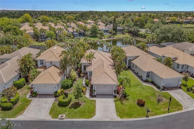 aerial view of residential area featuring a large body of water