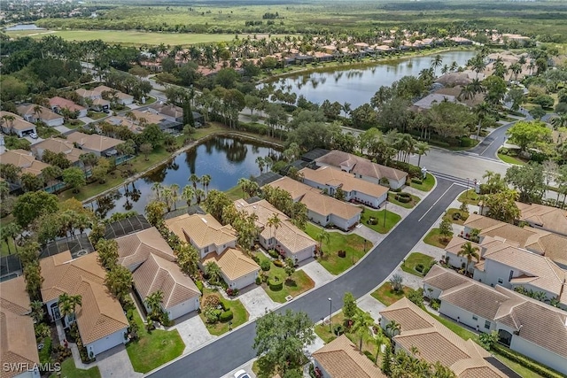 aerial view of property's location with nearby suburban area and a nearby body of water