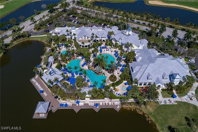 view of property location with a pool area, a large body of water, and a local golf course