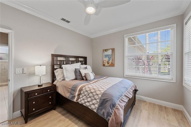 bedroom with light wood finished floors, baseboards, ornamental molding, and ceiling fan