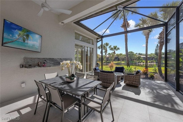 sunroom with a ceiling fan and an outdoor hangout area
