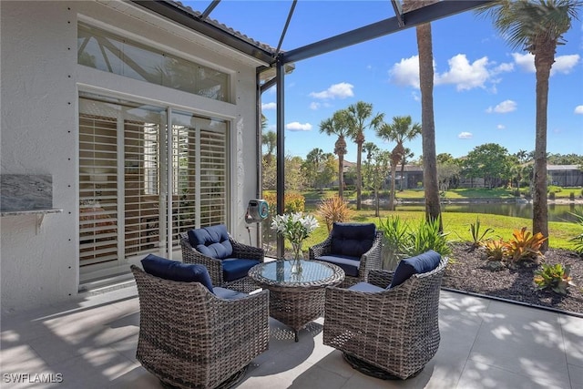 sunroom featuring a water view, plenty of natural light, and an outdoor living space
