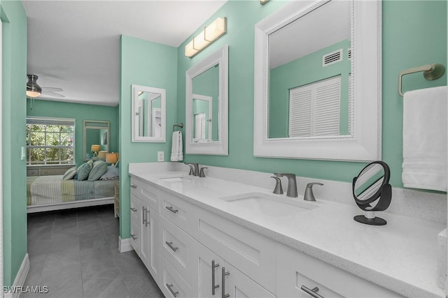 773 Wiggins Lake Dr Unit 102, Naples, FL 34110 - ensuite bathroom featuring double vanity, tile patterned floors, and ceiling fan