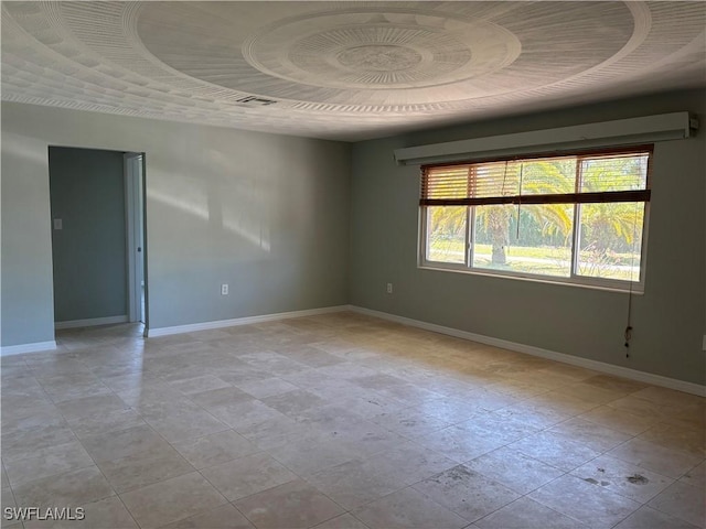 unfurnished room with baseboards