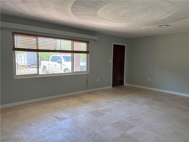 spare room with baseboards