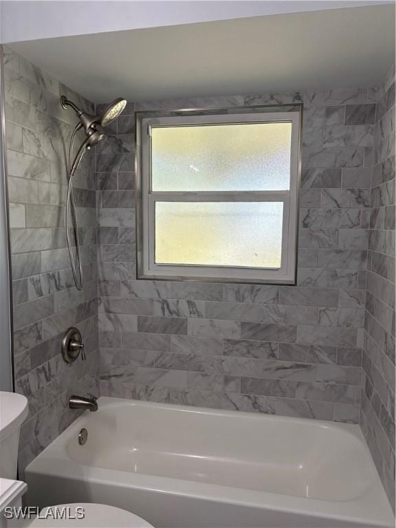 full bathroom featuring toilet, plenty of natural light, and shower / bathing tub combination