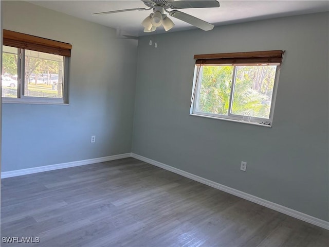 empty room with baseboards, ceiling fan, and plenty of natural light