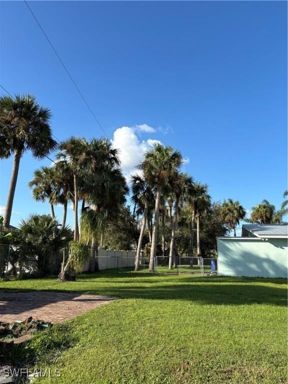 view of community with fence and a lawn