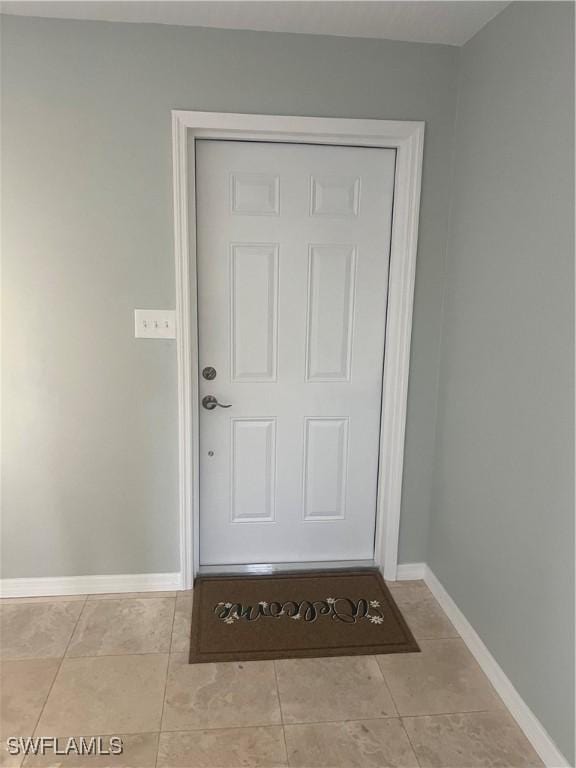 entrance to property featuring stucco siding