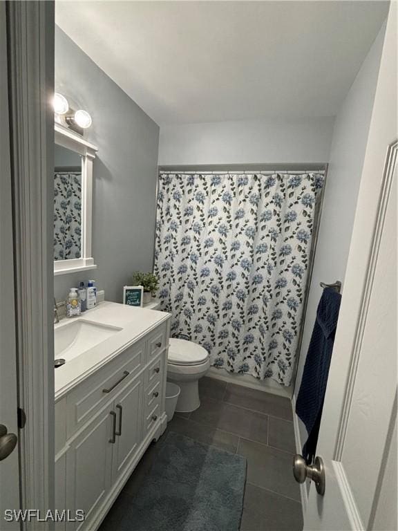 full bathroom with toilet, tile patterned flooring, vanity, and curtained shower