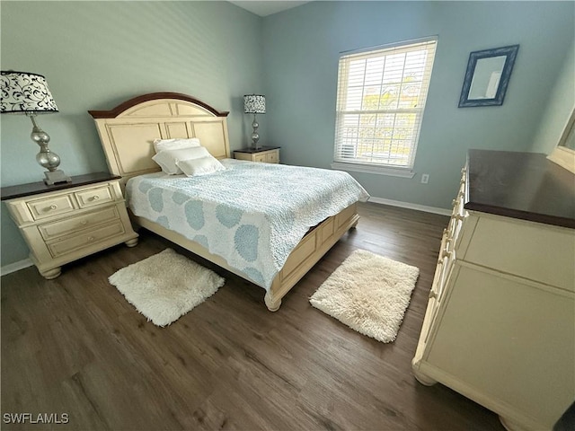 bedroom featuring baseboards and dark wood-style floors