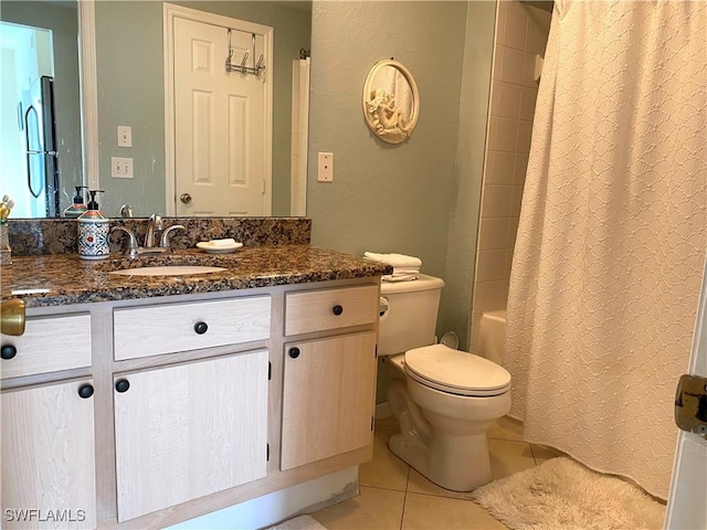 bathroom featuring vanity, toilet, and tile patterned floors