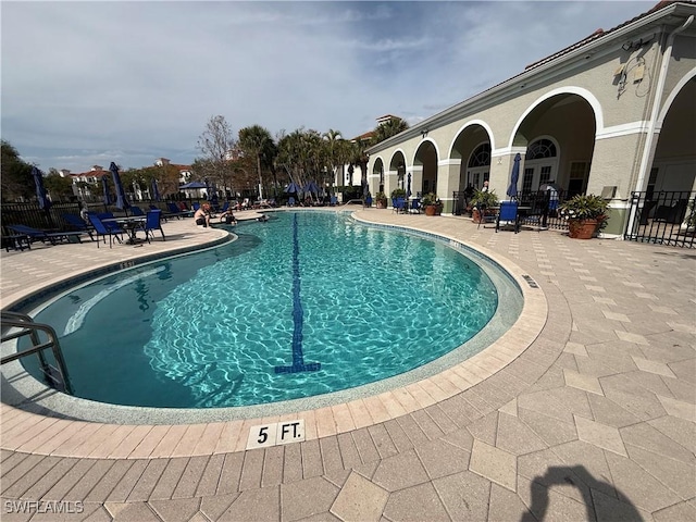 pool with fence and a patio