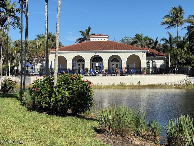 exterior space with a water view and fence