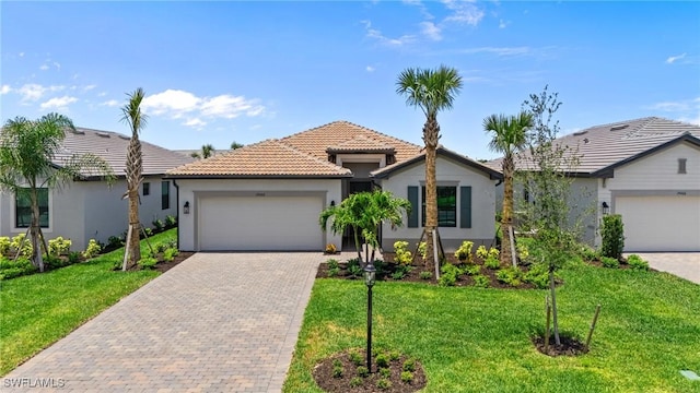 19402 Hinkley Dr, Estero, FL 33928 - ranch-style house with stucco siding, decorative driveway, an attached garage, a tiled roof, and a front lawn