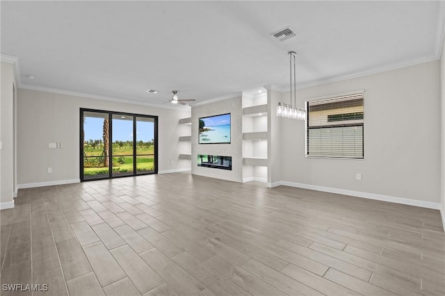 19402 Hinkley Dr, Estero, FL 33928 - unfurnished living room with crown molding, baseboards, ceiling fan, a large fireplace, and light wood-type flooring