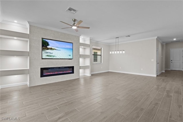 19402 Hinkley Dr, Estero, FL 33928 - unfurnished living room featuring baseboards, built in features, wood finished floors, a fireplace, and a ceiling fan