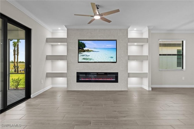 19402 Hinkley Dr, Estero, FL 33928 - unfurnished living room featuring built in features, baseboards, a tile fireplace, crown molding, and wood finished floors