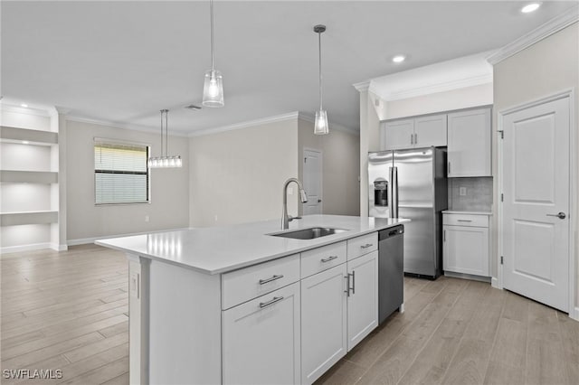19402 Hinkley Dr, Estero, FL 33928 - kitchen featuring appliances with stainless steel finishes, a sink, light countertops, crown molding, and light wood-style floors