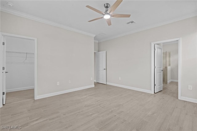 19402 Hinkley Dr, Estero, FL 33928 - unfurnished bedroom featuring a spacious closet, ornamental molding, light wood-type flooring, baseboards, and a closet