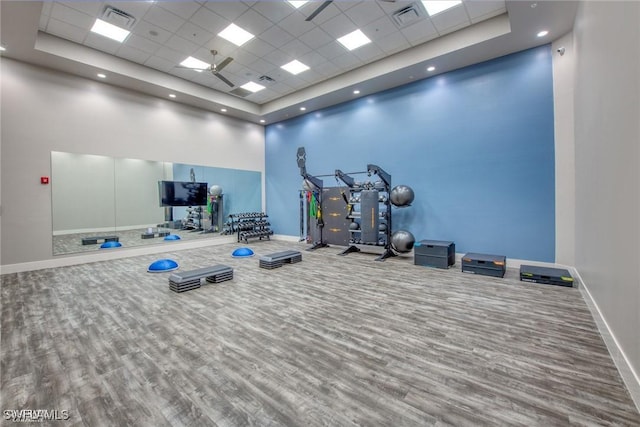 19402 Hinkley Dr, Estero, FL 33928 - exercise room featuring a drop ceiling, wood finished floors, a high ceiling, baseboards, and a raised ceiling