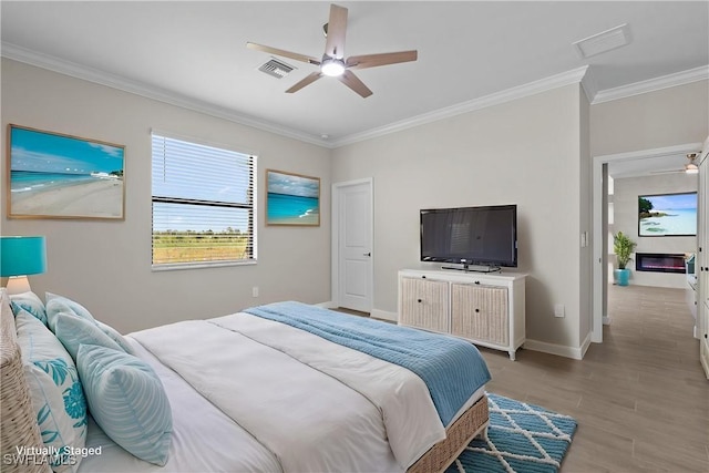 19402 Hinkley Dr, Estero, FL 33928 - bedroom with ornamental molding, light wood-type flooring, baseboards, and ceiling fan