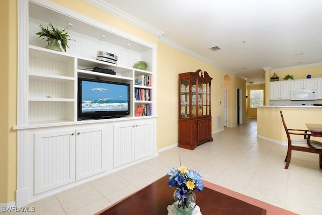 4873 Hampshire Ct Unit 5-101, Naples, FL 34112 - living area with light tile patterned floors, visible vents, baseboards, built in shelves, and ornamental molding