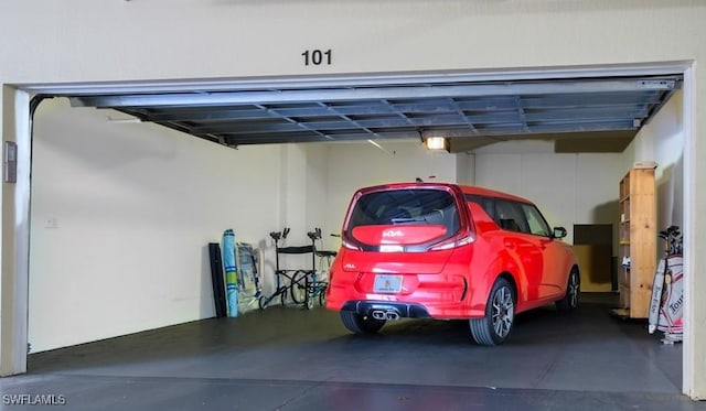 4873 Hampshire Ct Unit 5-101, Naples, FL 34112 - garage featuring a garage door opener
