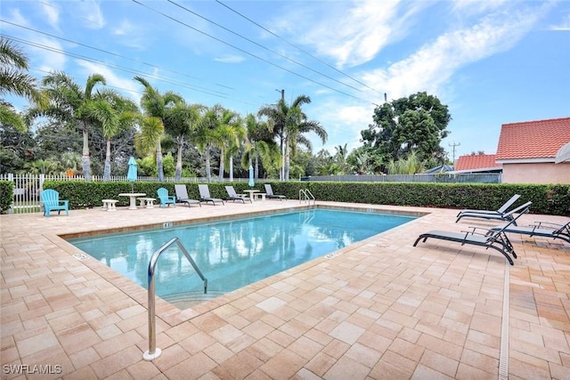 1273 Naples Lake Dr, Naples, FL 34104 - community pool featuring a patio and fence