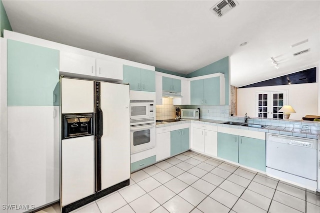 1273 Naples Lake Dr, Naples, FL 34104 - kitchen with a sink, visible vents, white appliances, under cabinet range hood, and lofted ceiling