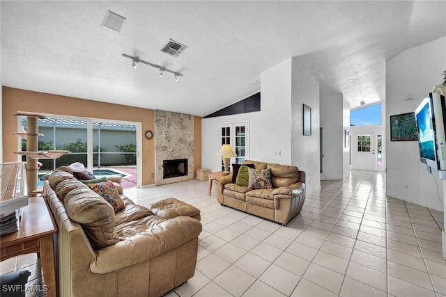 1273 Naples Lake Dr, Naples, FL 34104 - living area with track lighting, light tile patterned floors, visible vents, and a fireplace