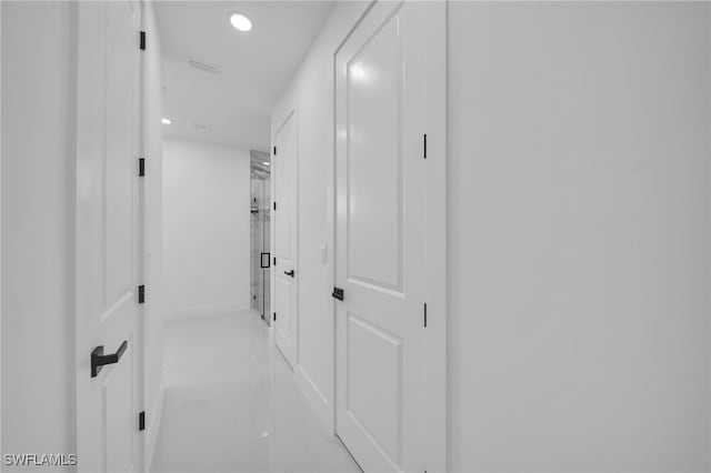 hall with marble finish floor, baseboards, and recessed lighting