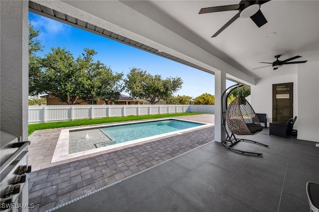 view of pool with a ceiling fan, a patio area, a fenced in pool, and a fenced backyard