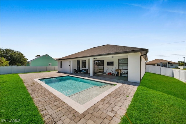 view of swimming pool with a yard, a fenced in pool, a patio, ceiling fan, and a fenced backyard