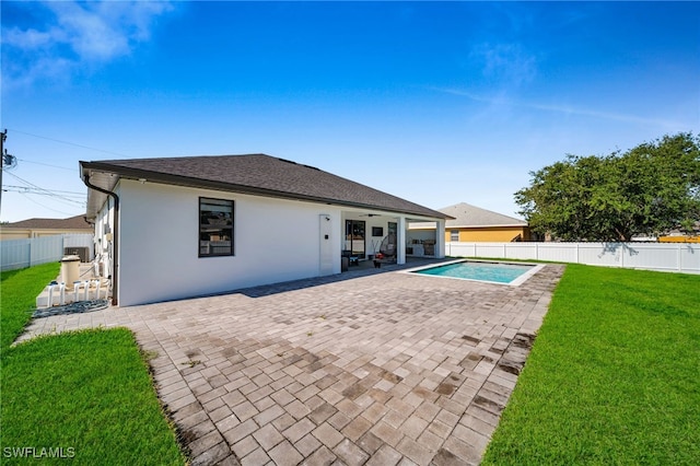 view of pool with a patio area, a fenced backyard, ceiling fan, a fenced in pool, and a lawn