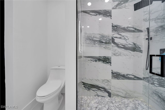 full bath with toilet and a marble finish shower