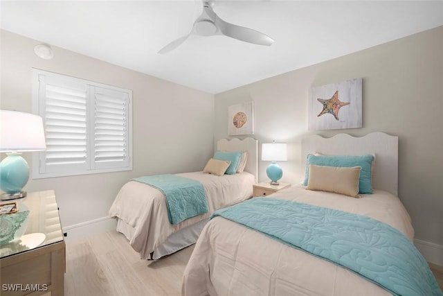 bedroom with baseboards, a ceiling fan, and wood finished floors