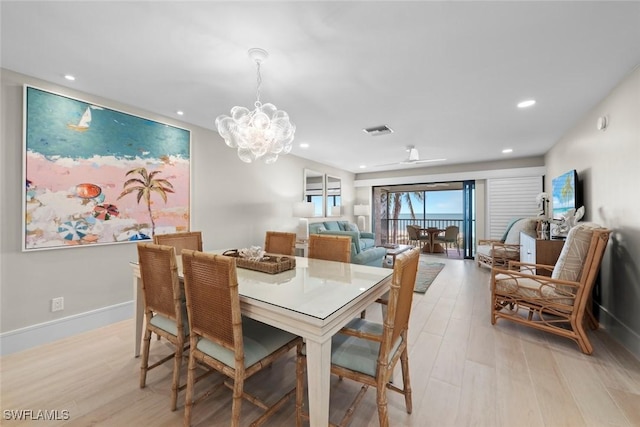 dining space featuring an inviting chandelier, light wood-type flooring, visible vents, and recessed lighting