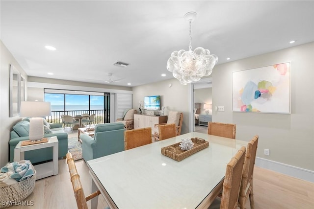 dining space with recessed lighting, a notable chandelier, light wood-style flooring, and visible vents