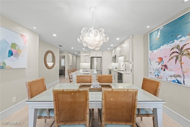 dining area featuring a notable chandelier, baseboards, and recessed lighting