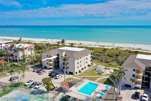 drone / aerial view featuring a water view and a beach view