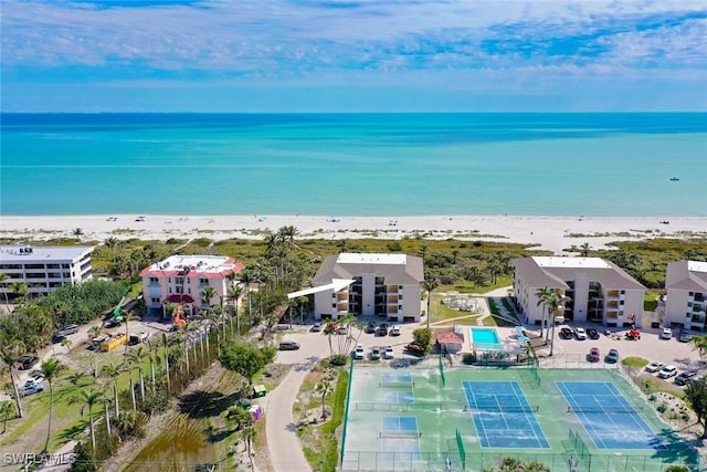 birds eye view of property with a water view and a view of the beach