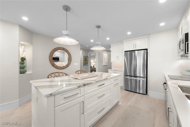 kitchen featuring white cabinets, appliances with stainless steel finishes, and a center island