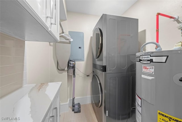utility room featuring stacked washer / dryer, water heater, and electric panel