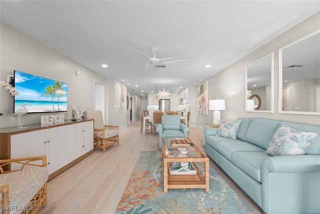 living room featuring ceiling fan, light wood-style flooring, visible vents, and recessed lighting