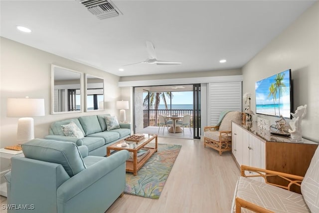 living room with ceiling fan, recessed lighting, light wood-style flooring, and visible vents