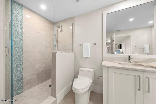 full bathroom featuring toilet, wood finished floors, vanity, recessed lighting, and a walk in shower