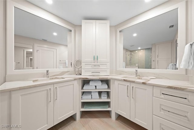 full bathroom featuring a stall shower, recessed lighting, vanity, and visible vents