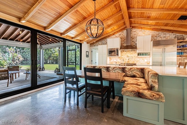 dining area featuring wood ceiling, brick wall, a chandelier, and concrete flooring